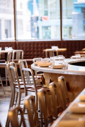 bar seating counter set with plates and glasses