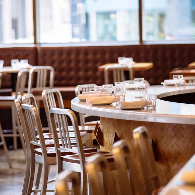bar seating counter set with plates and glasses